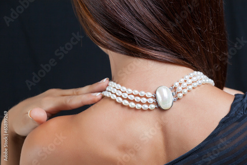 Woman with pearl necklace on her neck