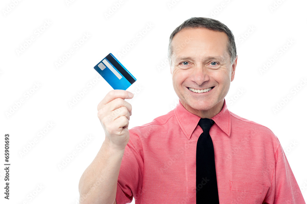 Smiling executive showing debit card Smiling executive showing debit card