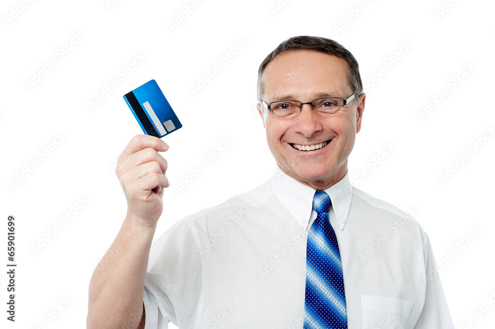 Successful businessman holding a credit card