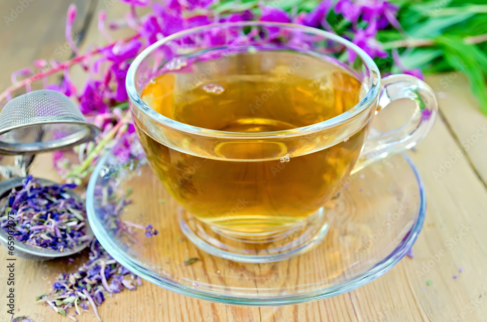 Herbal tea from fireweed in cup with strainer Herbal tea from fireweed in cup with strainer