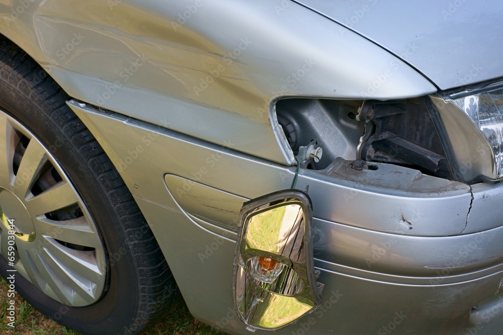 Car crash, the vehicle with a damaged fender, bumper and blinker