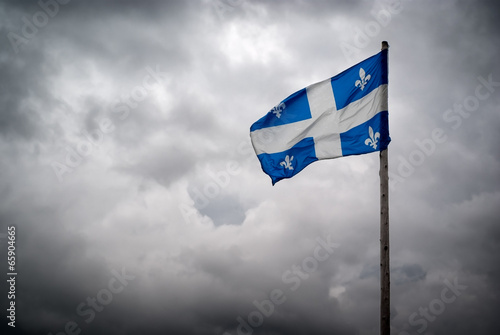 Quebec Flags Waves Before Stormy, Cloudy Skies
