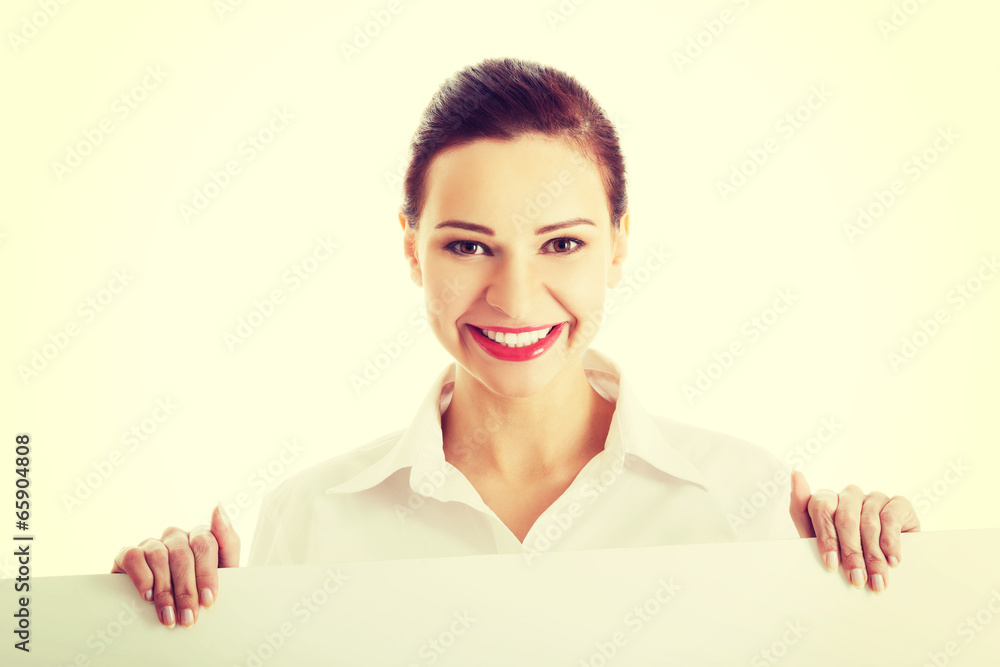 Beautiful young business woman holding copy space. Beautiful young business woman holding copy space.