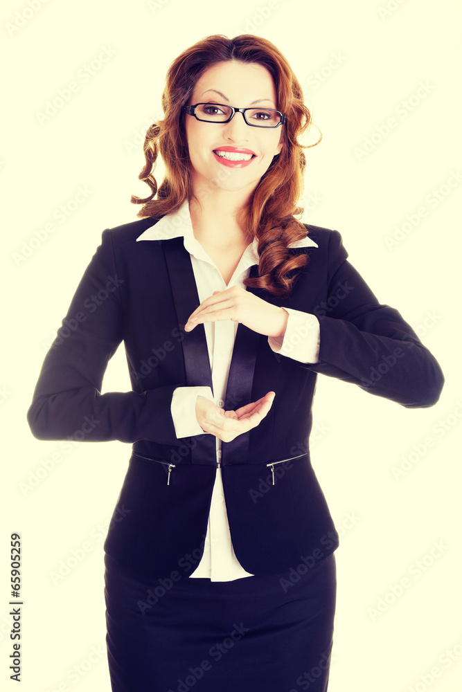 Businesswoman showing copy space on her palm Businesswoman showing copy space on her palm