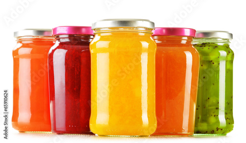 Jars of fruity jams isolated on white background