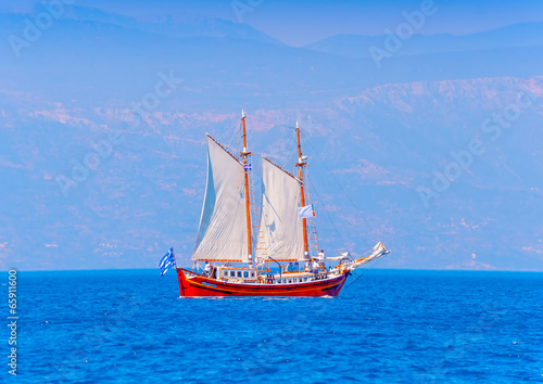 Old wooden red Greek boat (Perama) in Spetses island in Greece