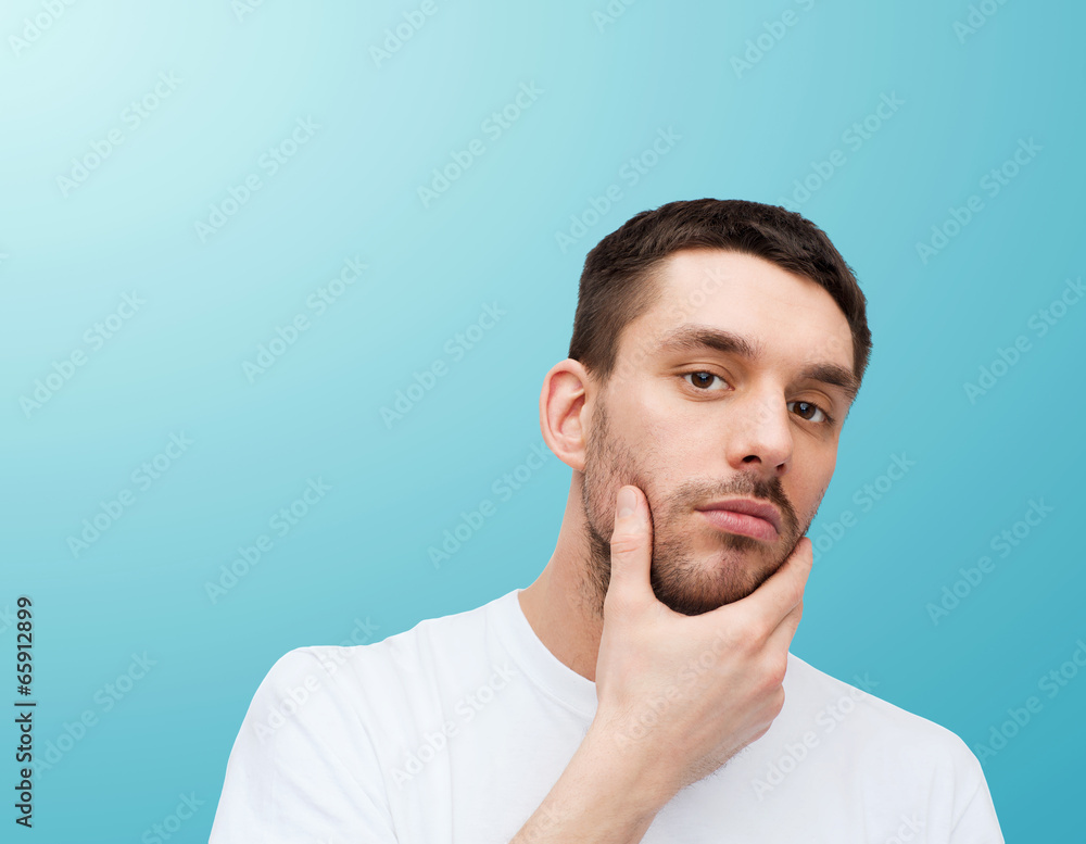 beautiful calm man touching his face beautiful calm man touching his face