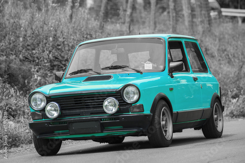 Blue compact  car on black and white background