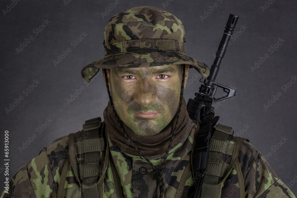 Young soldier with jungle camouflage paint. Young soldier with jungle camouflage paint.