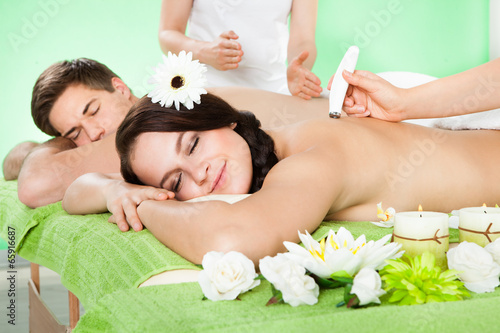 Woman Receiving Microdermabrasion Therapy At Beauty Spa