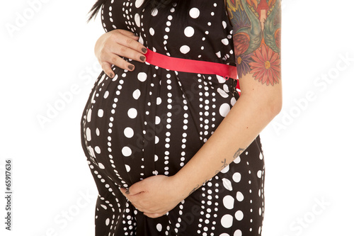 woman pregnant belly close dot dress hand over and under