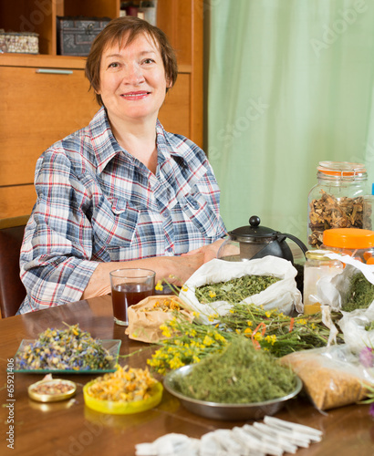 Smiling mature woman with  herbs photo