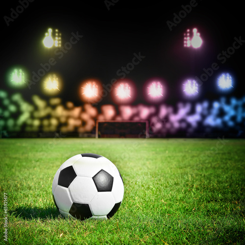 football on the grass field with stadium light