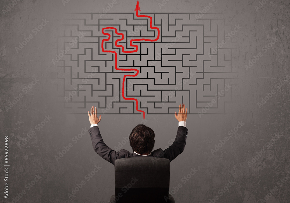 Business man looking at a maze and the way out Business man looking at a maze and the way out