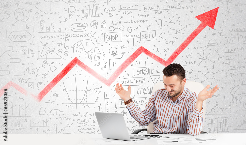 Business man sitting at table with market diagrams Business man sitting at table with market diagrams