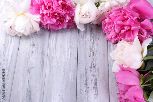 Beautiful pink and white peonies on color wooden background © Africa Studio