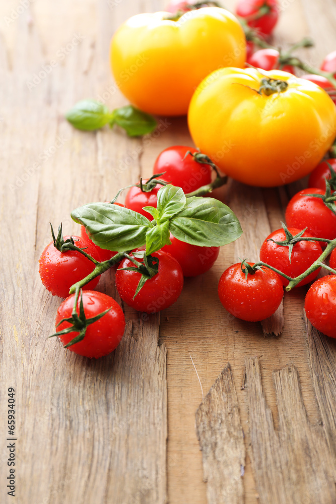 Fresh cherry tomatoes on old wooden table Fresh cherry tomatoes on old wooden table