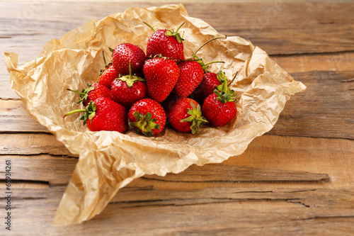 Red ripe strawberries with chocolate on wooden table