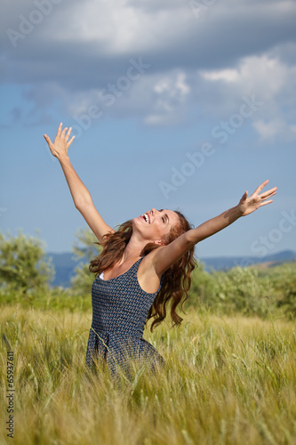 Woman in wheat field enjoying  freedom concept