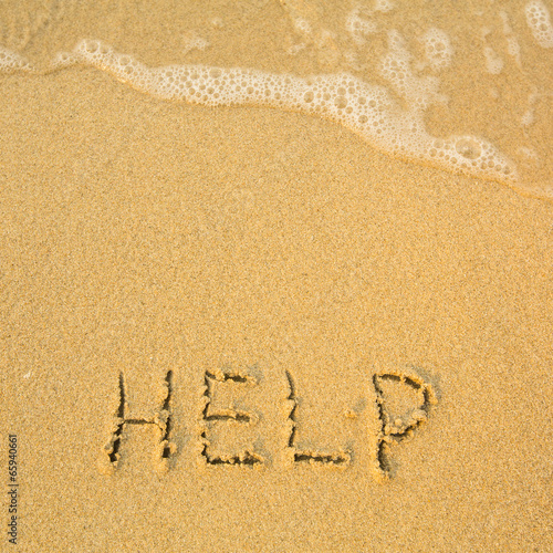 Help - written in sand on beach texture - soft wave of the sea. © De Visu