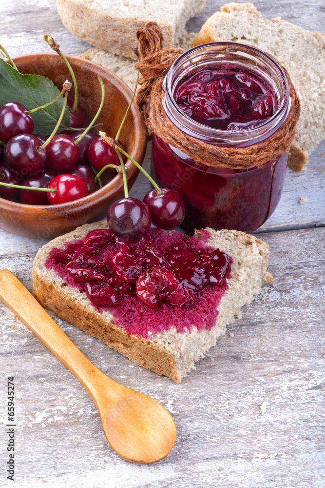 Homemade jam from organic cherries on wholemeal bread Homemade jam from organic cherries on wholemeal bread
