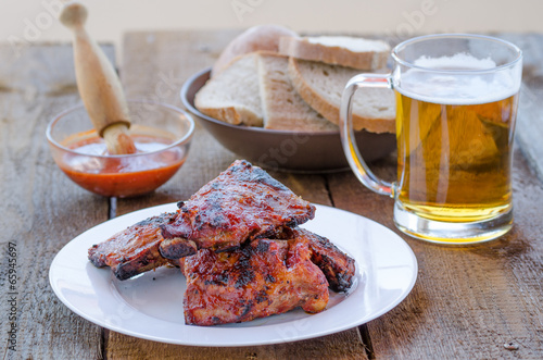 Spareribs on grill with hot marinade, czech beer