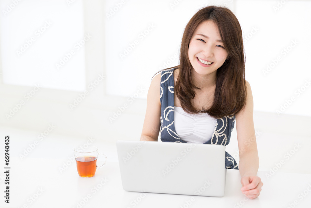 部屋でパソコンを使う女性 部屋でパソコンを使う女性