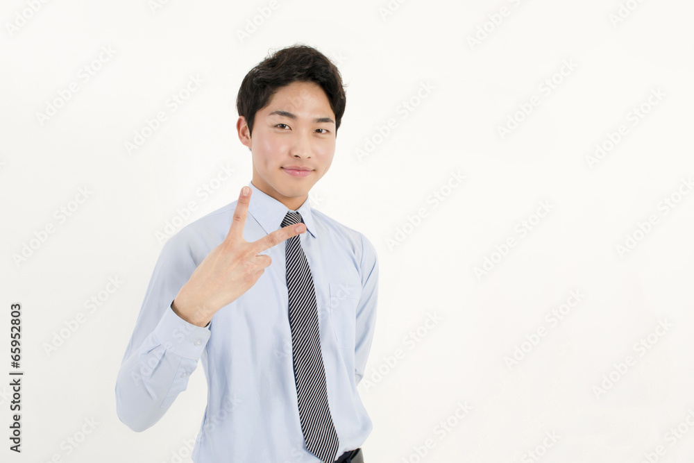 Asian young businessman with two fingers peace sign hand gesture Asian young businessman with two fingers peace sign hand gesture