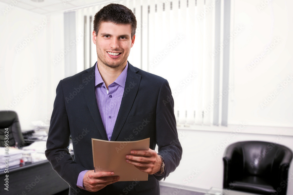 Successful young business man,inside his office. Successful young business man,inside his office.