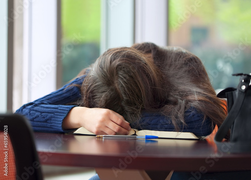 Young college or high school student asleep on table