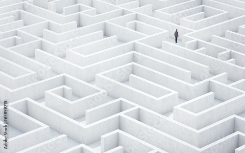 Businessman looking for way out of a maze