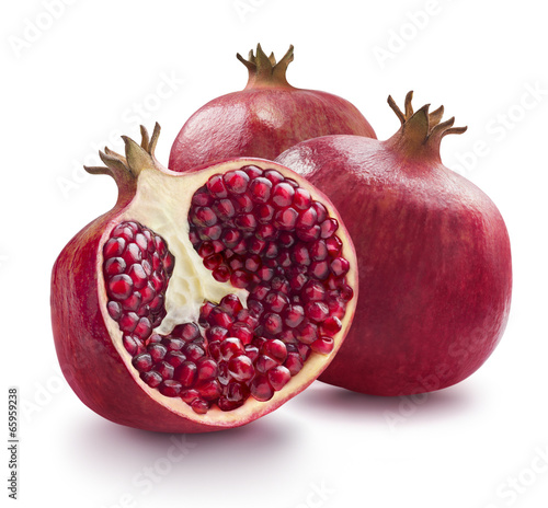 Two whole and one half of pomegranate isolated on white backgrou