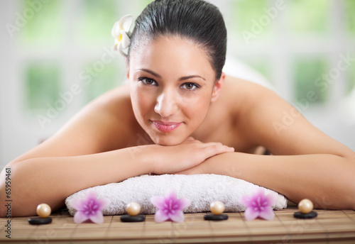 young beautiful woman relaxing in spa center