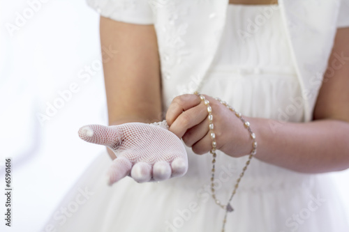 Young girl dressing for her First Communion