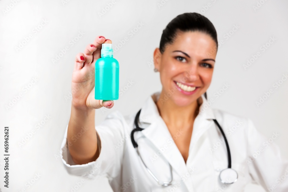 beautiful woman doctor presenting new medicine in bottle beautiful woman doctor presenting new medicine in bottle