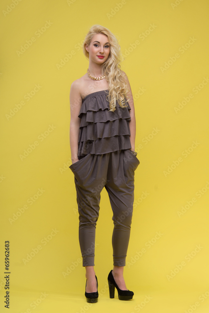 Woman standing on yellow background Woman standing on yellow background