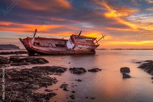 Fishing boat moored on the beach at sunset