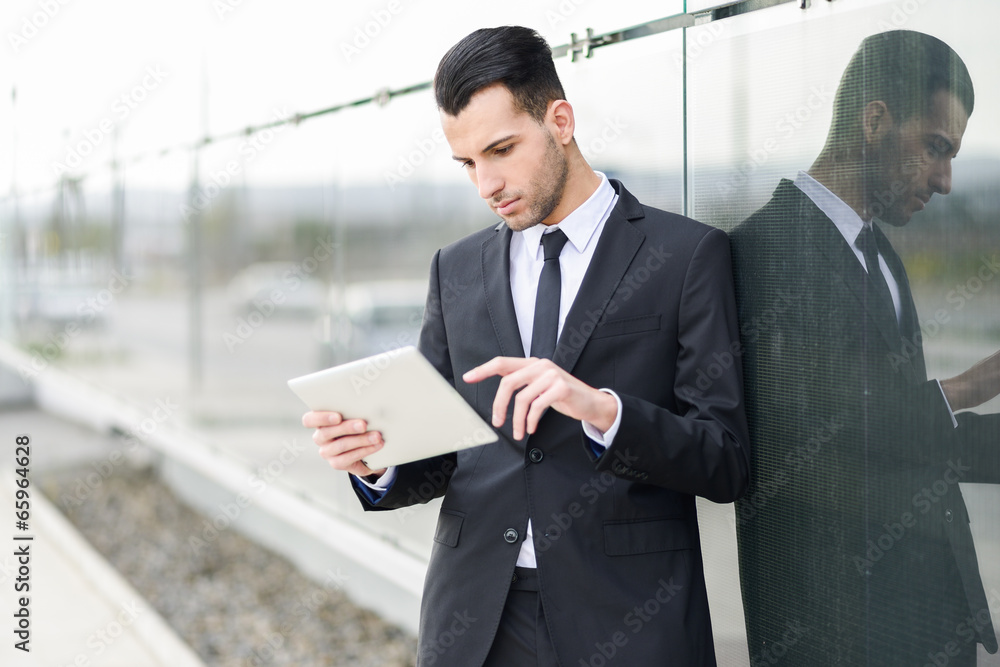 Businessman with tablet computer in office building Businessman with tablet computer in office building
