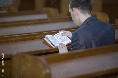 Man reading the Bible in church