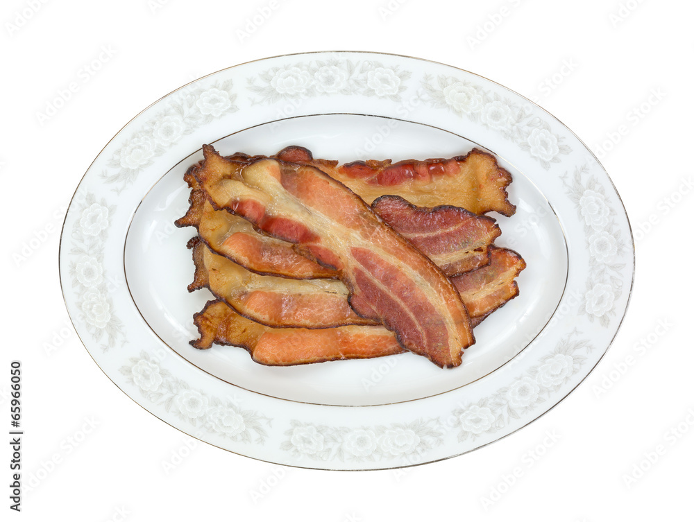 Cooked smoked bacon slices on platter Cooked smoked bacon slices on platter