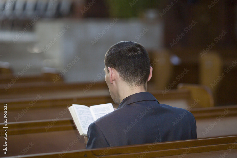 Man reading the Bible in church Man reading the Bible in church