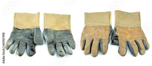 Fotografie A dirty and well-worn pair of canvas and leather work gloves on