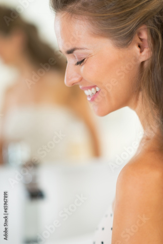 Free Download Portrait of happy young woman in bathroom - GFXLoad