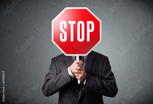 Businessman holding a stop sign photo