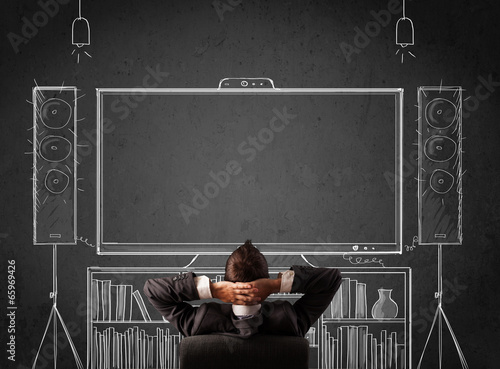 Bild auf Leinwand Businessman in front of a home cinema system