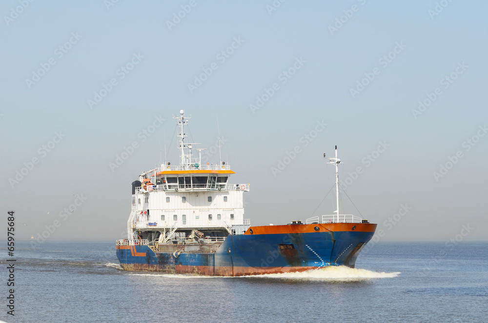Large cargo ship sailing in still water