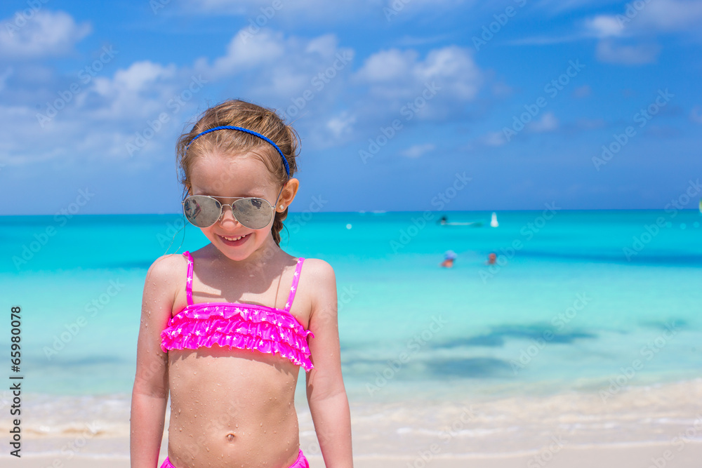 Adorable little girl during tropical beach vacation