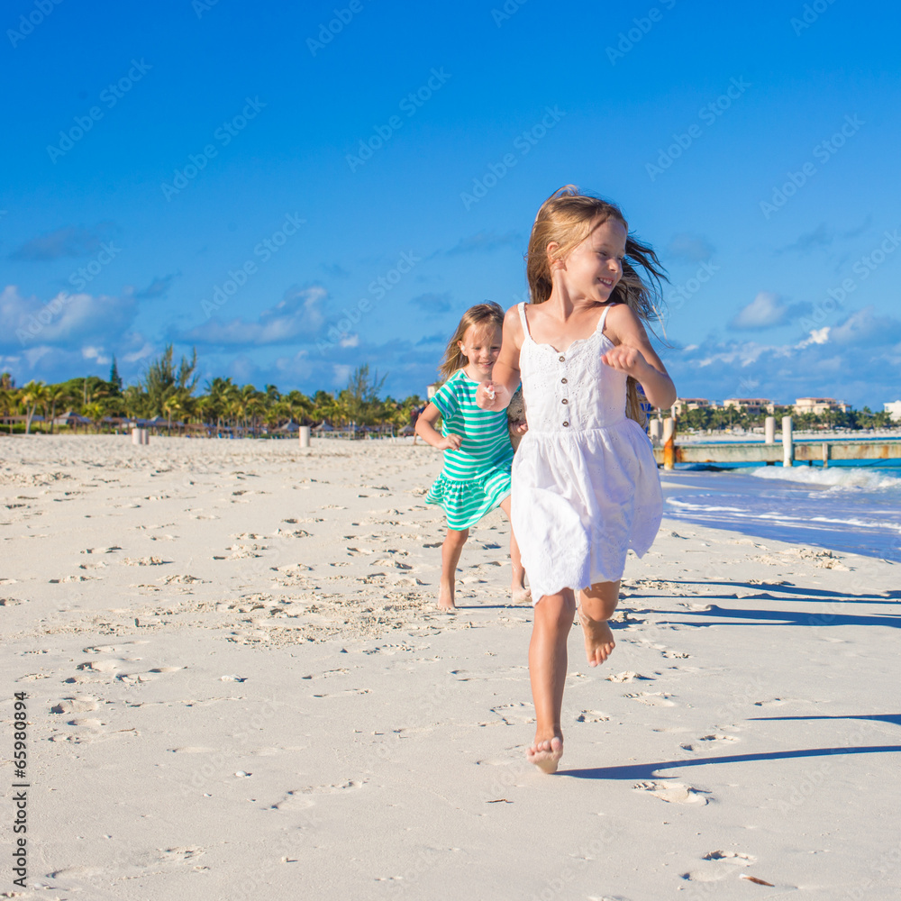 Young happy girls having fun at exotic beach on sunny day Young happy girls having fun at exotic beach on sunny day