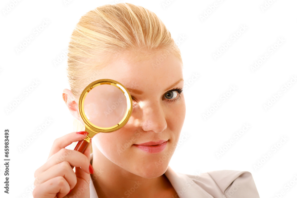 Young attractive smiling businesswoman looking into a magnifying Young attractive smiling businesswoman looking into a magnifying