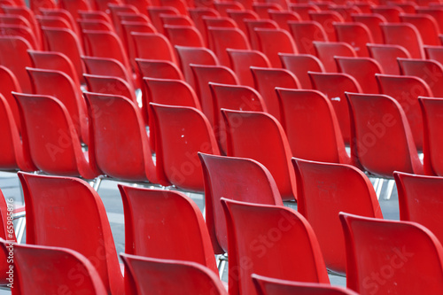Red empty seats in stadium